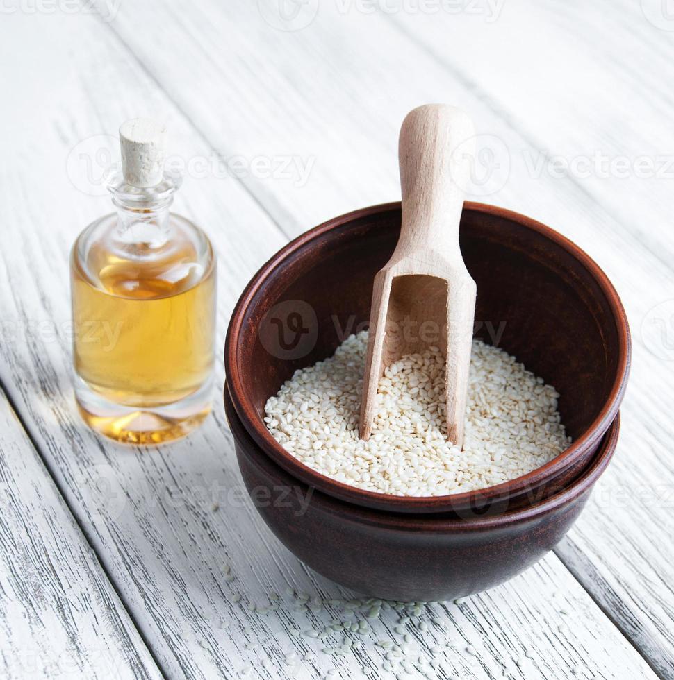 Bowl with sesame seeds and oil photo