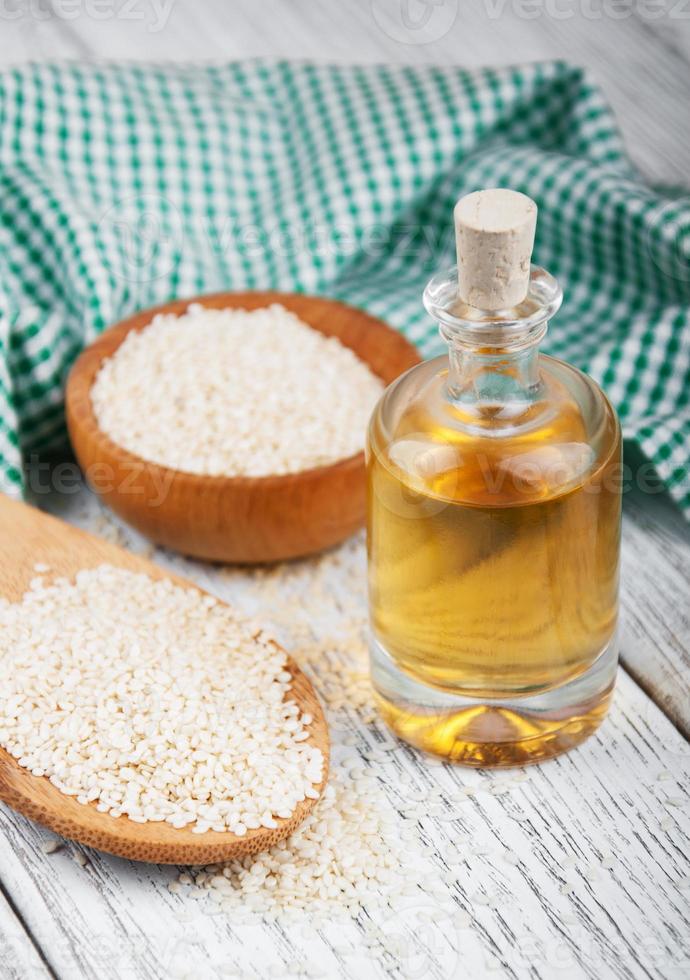 Sesame seeds and bottle with oil photo