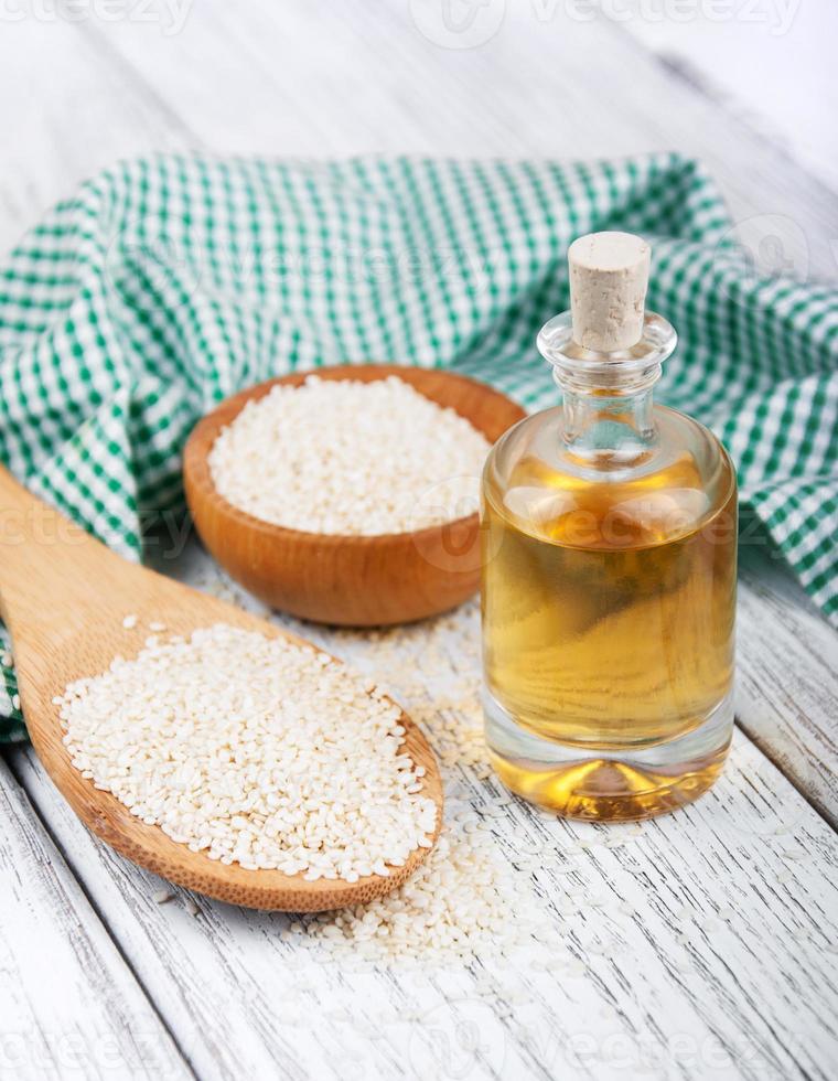 Sesame seeds and bottle with oil photo