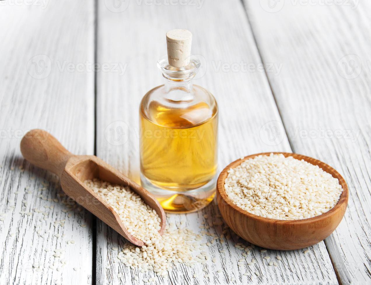 Sesame seeds and bottle with oil photo