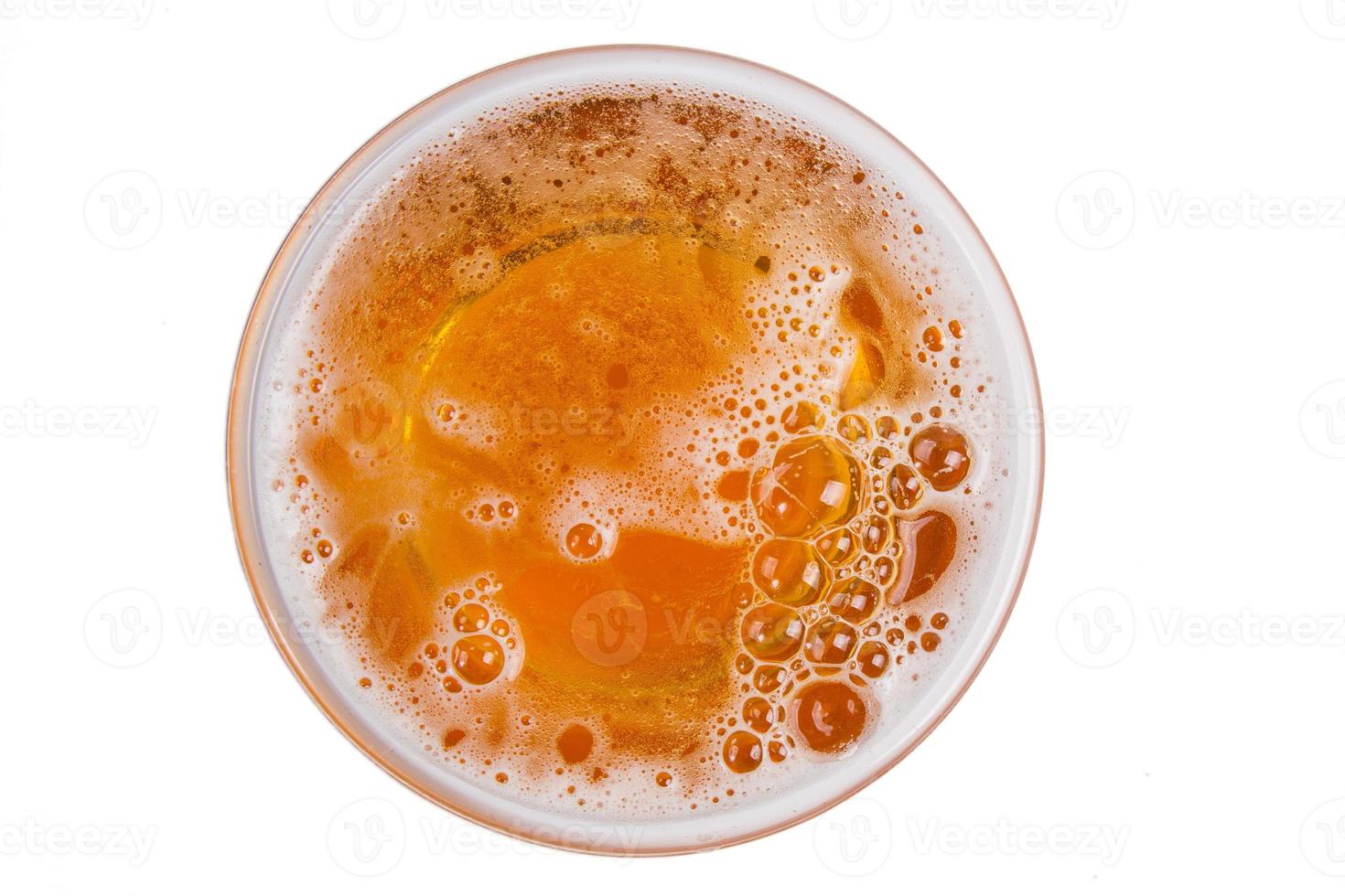Beer in glass. Beer foam isolated on white background. View from above. photo