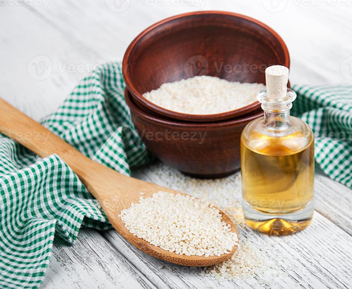 Sesame seeds and bottle with oil photo