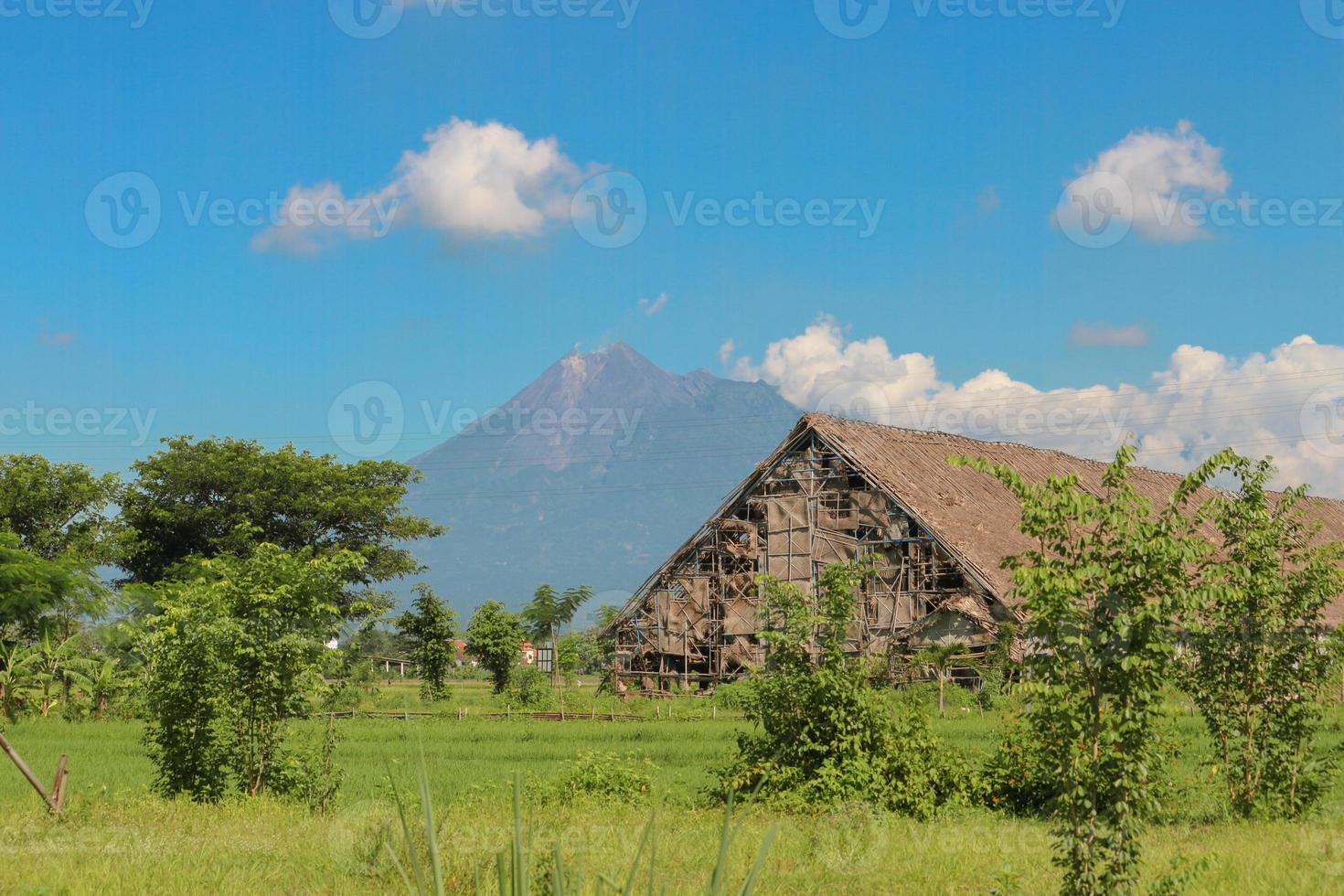Outside the Tobacco house or Los Tembakau or Los Mbako, warehouse for storing and drying harvested tobacco leaves in Klaten Regency, Central Java, Indonesia with Merapi Mountain Background photo