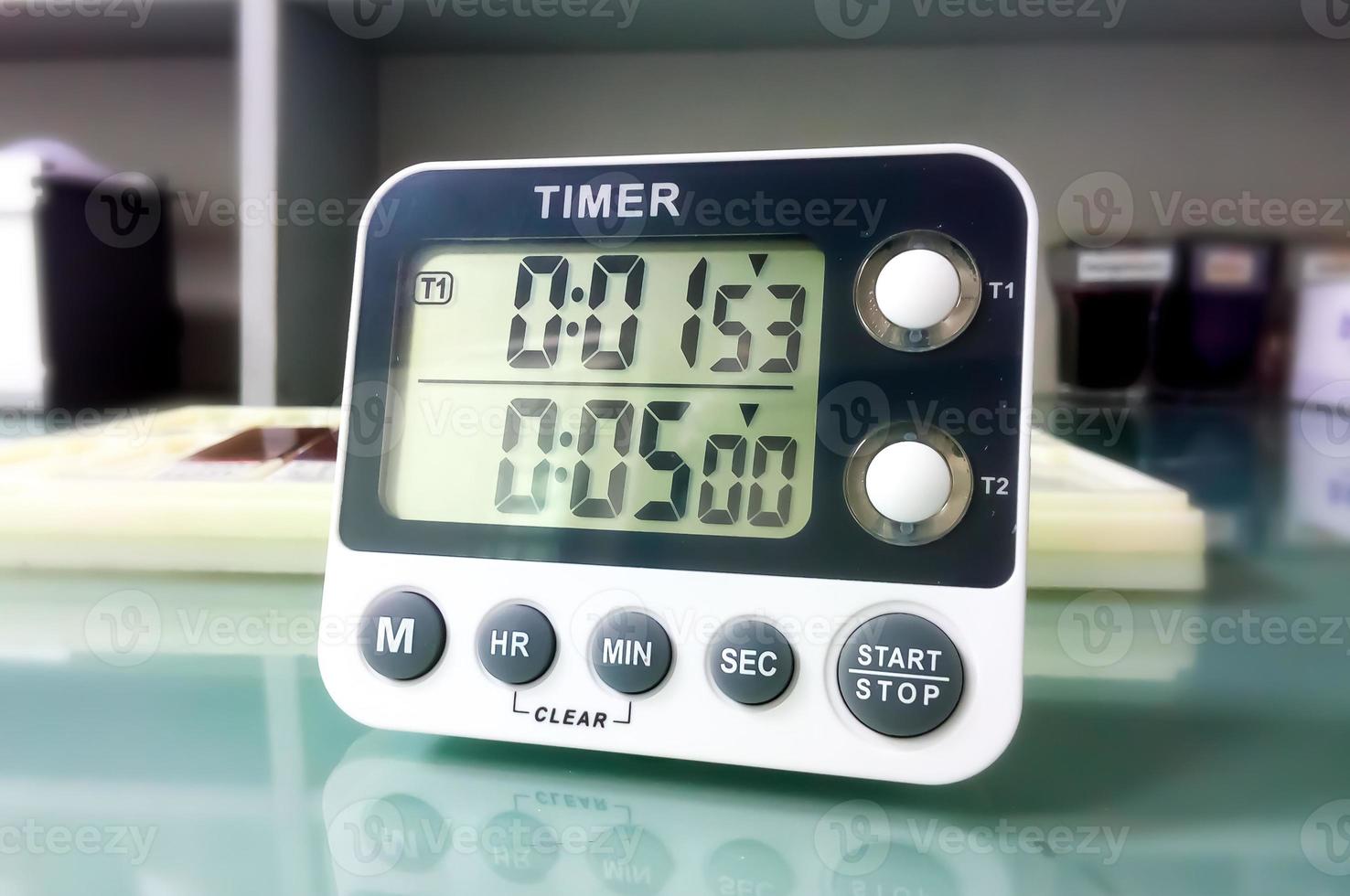 Closeup stop watch in laboratory. Timer. Laboratory test time counting concept.Stopwatch. photo