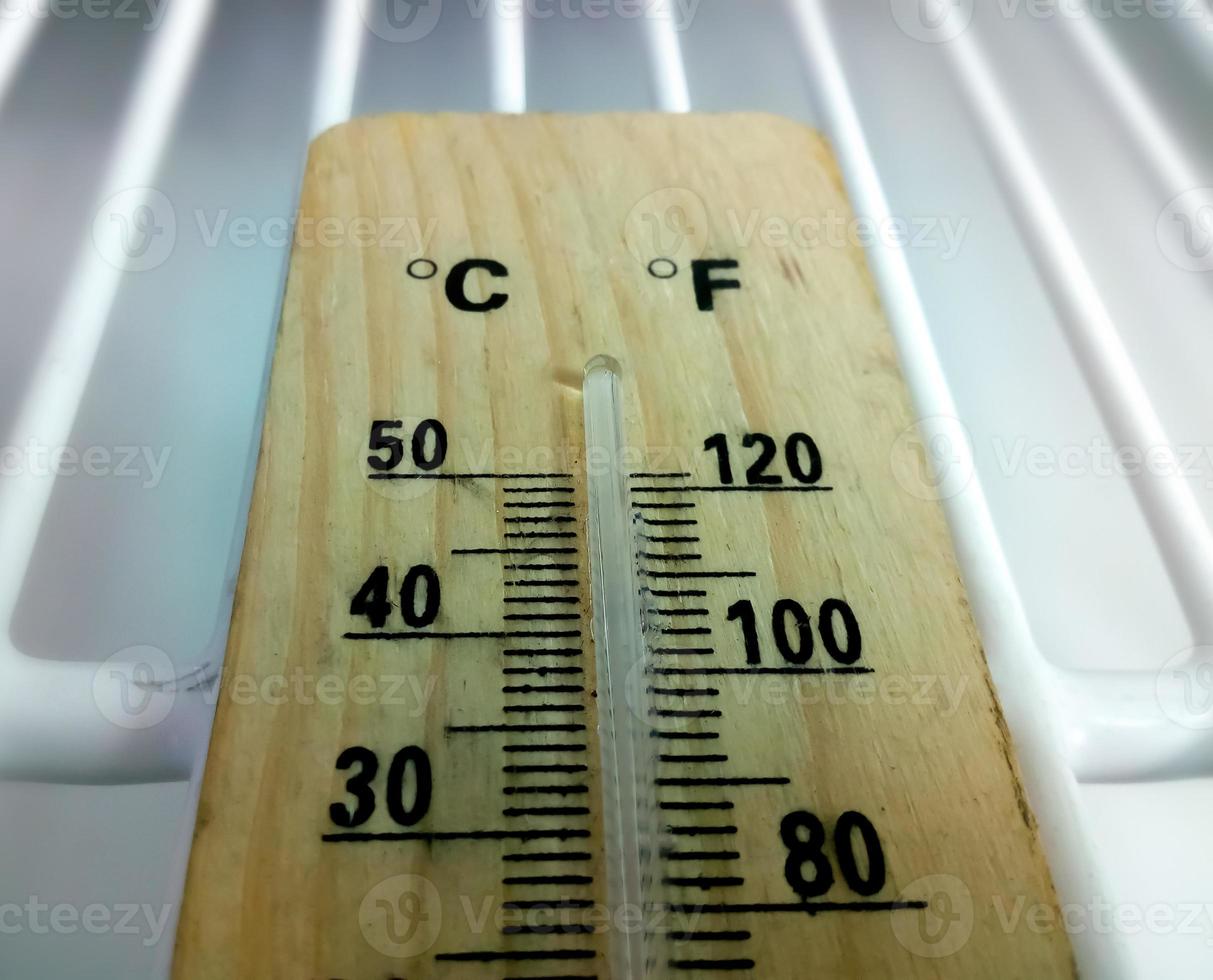 Analog thermometer. closeup. Fridge thermometer. Food, chemical or reagent safety. Refrigerator temperature monitoring device. Mercury thermometer. photo