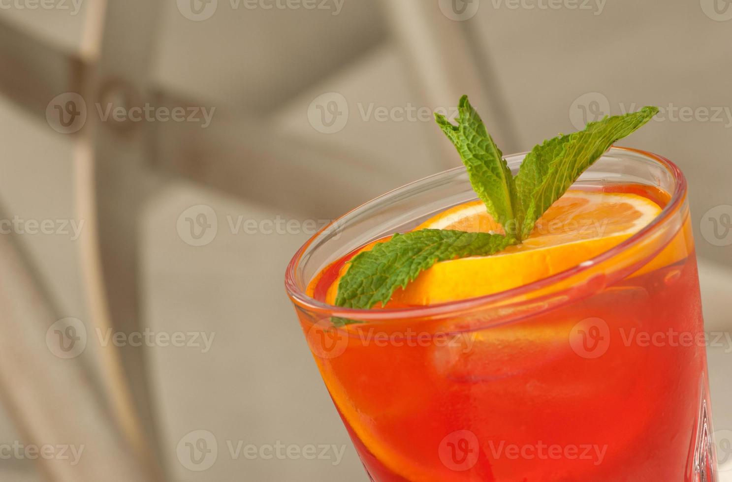 a glass with a drink on the table photo