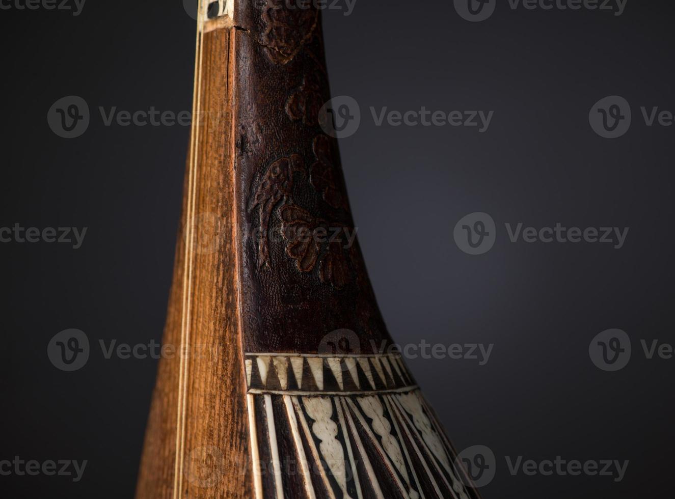 part ancient Asian stringed musical instrument on black background with backlight photo