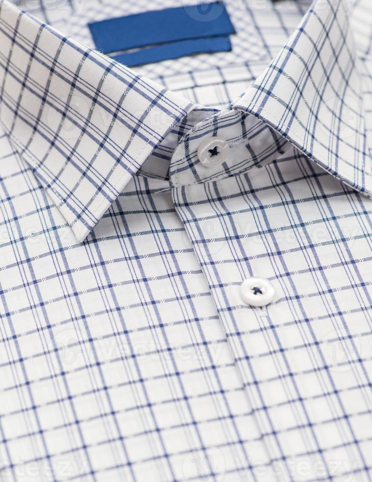 cotton shirt with a focus on the collar and button, closeup photo