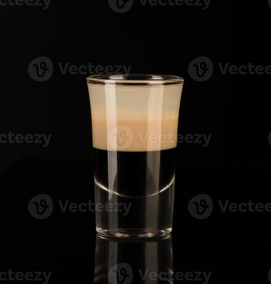 shot glass with alcohol on a dark background photo