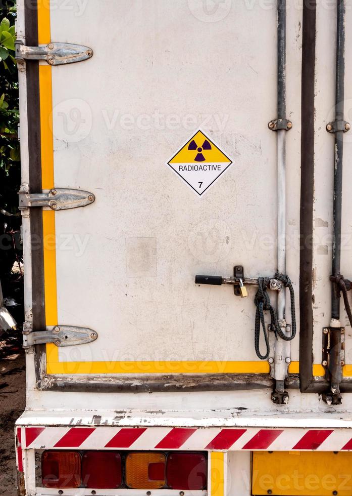 Radiation warning sign on the Dangerous goods transport label Class 7 at the container of transport truck photo