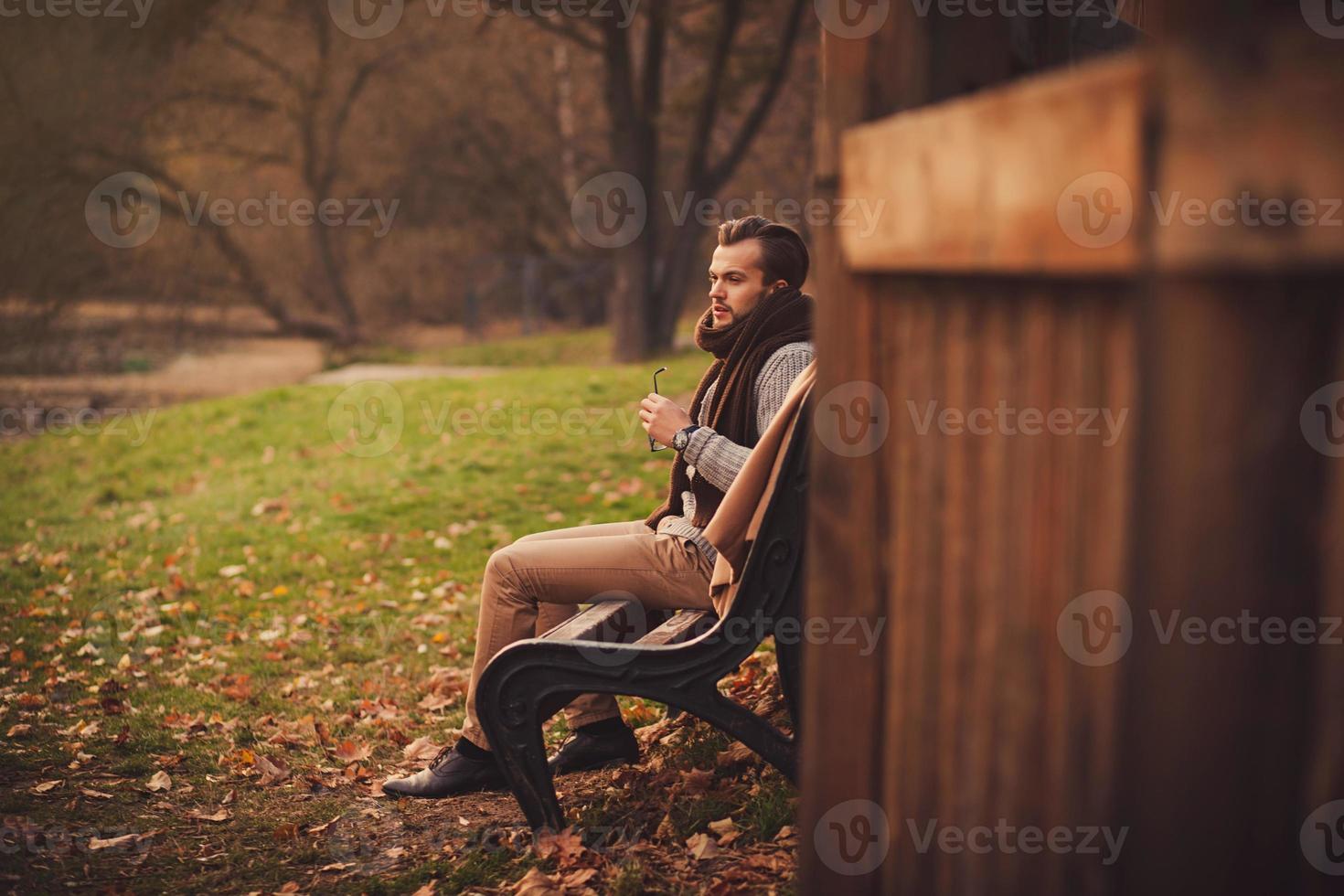 man sitting alone on a bench photo