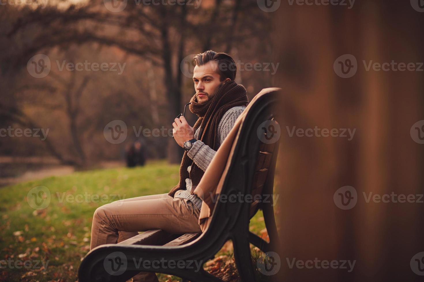 young man sitting on bench photo