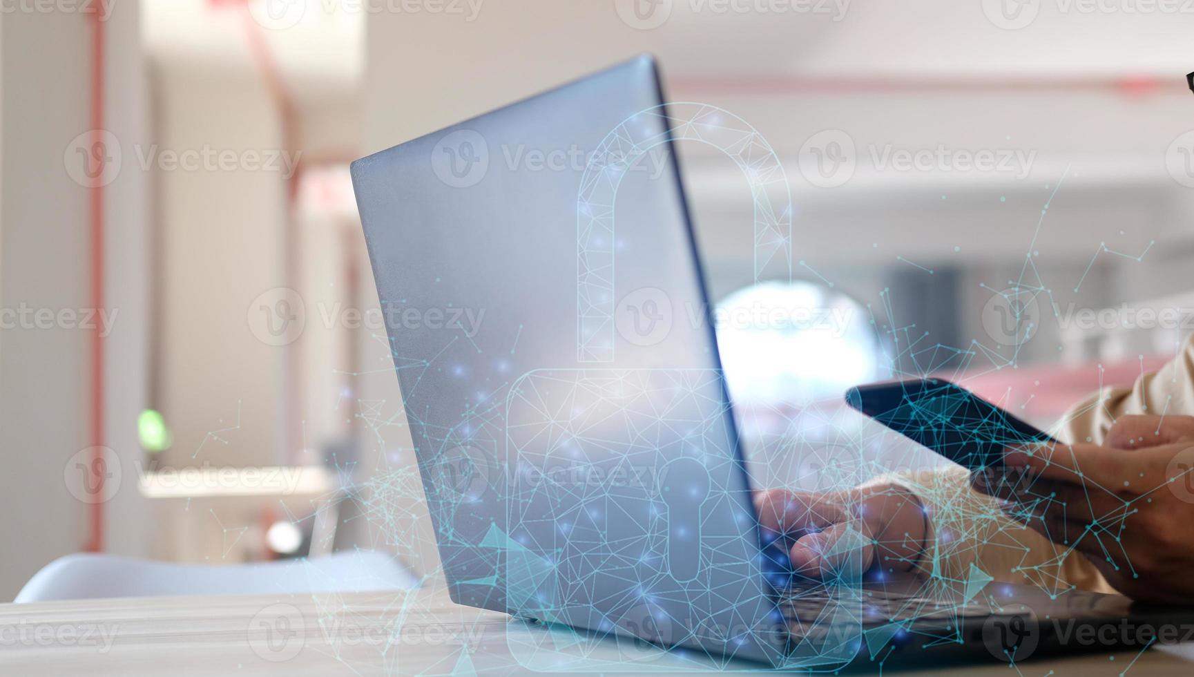 Hands working on a computer and a lock holographic drawing are both double-exposed. Concept of security. photo