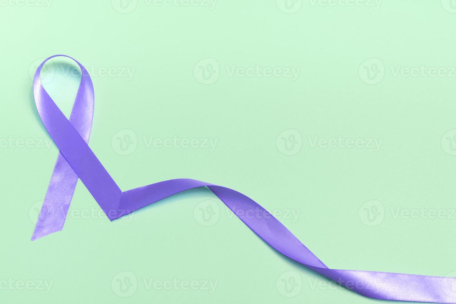 Closeup purple ribbon on a blue background with copy space. World epilepsy day.Banner photo