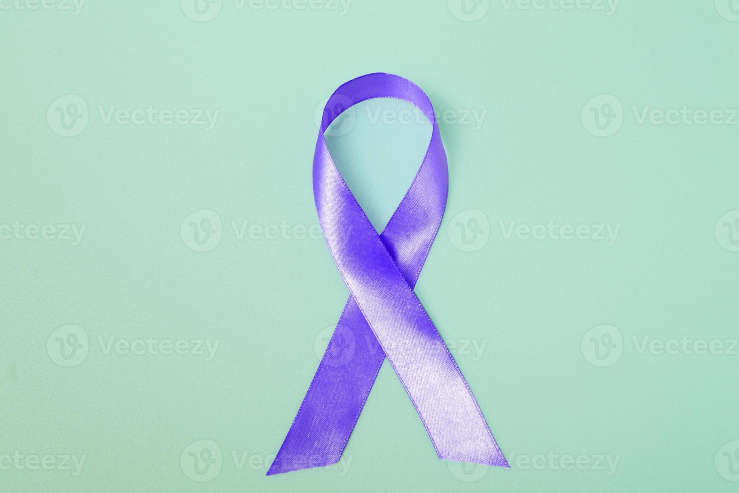 Closeup purple ribbon on a blue background with copy space. World epilepsy day.Banner photo