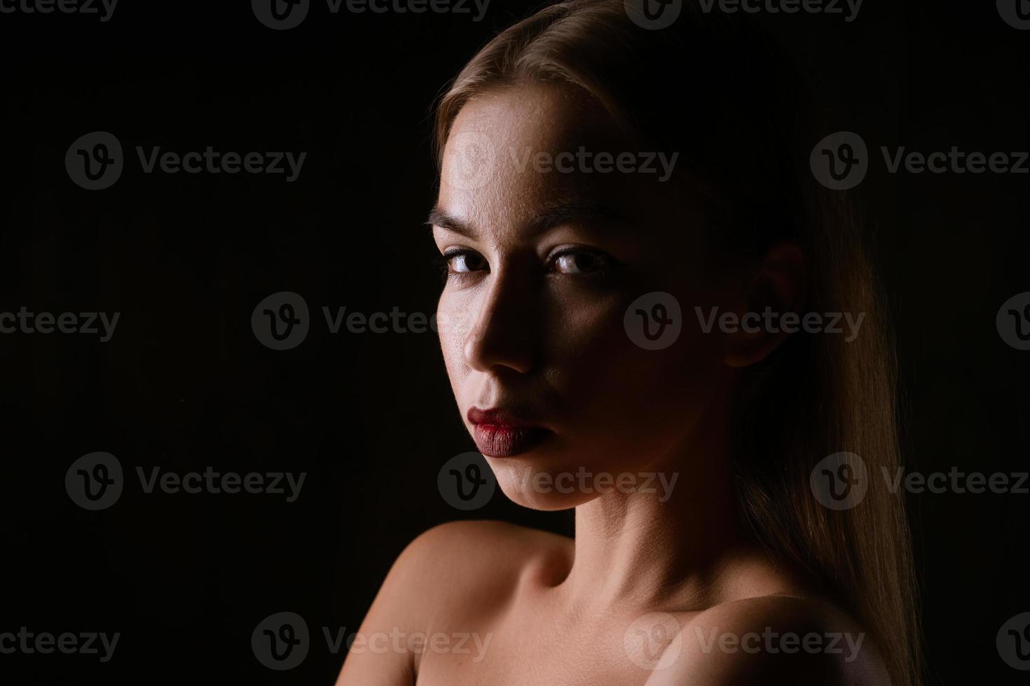 Close-up portrait of a beautiful young woman , dark photo