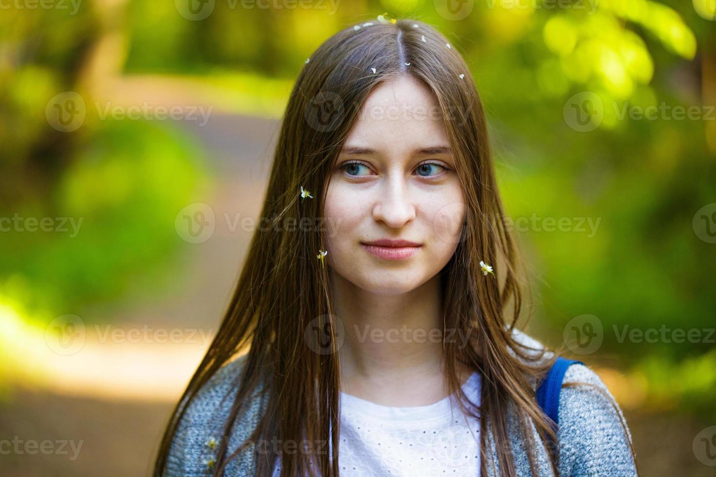 Female portrait of a young woman in the park on the path photo