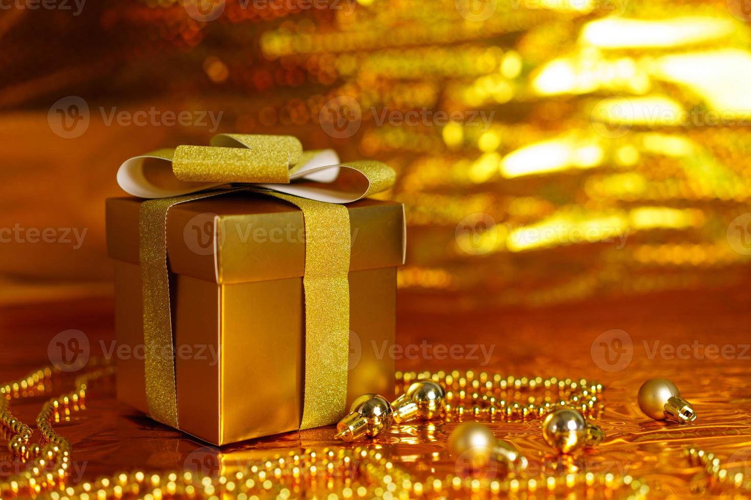 golden gift box on shiny background photo