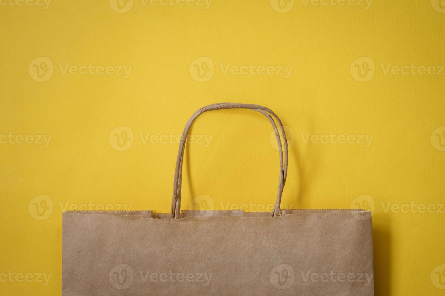 Paper bag on a yellow background photo