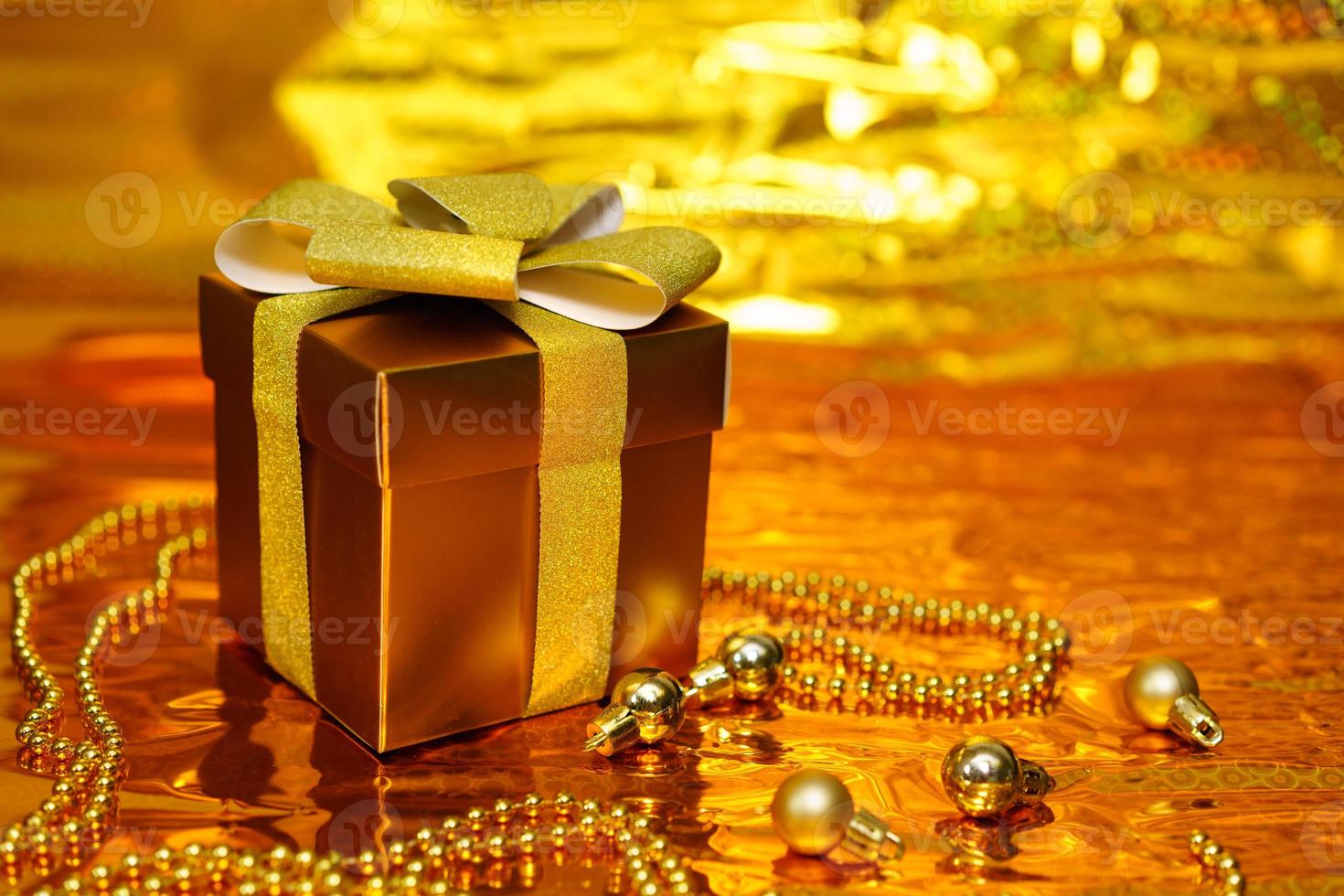 golden gift box on shiny background photo