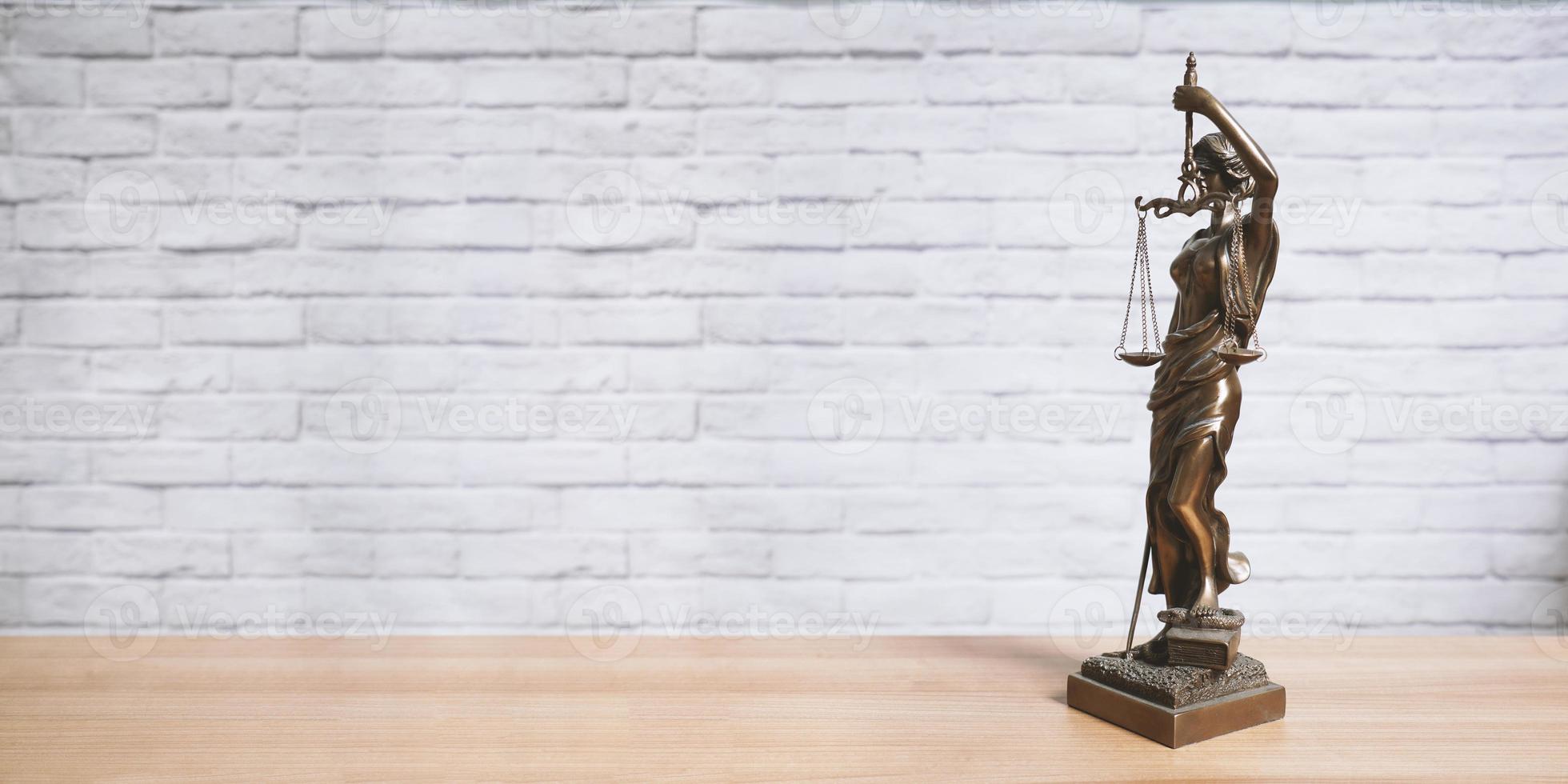 Lady Justice or Justitia statue on desk - legal law jurisdiction photo