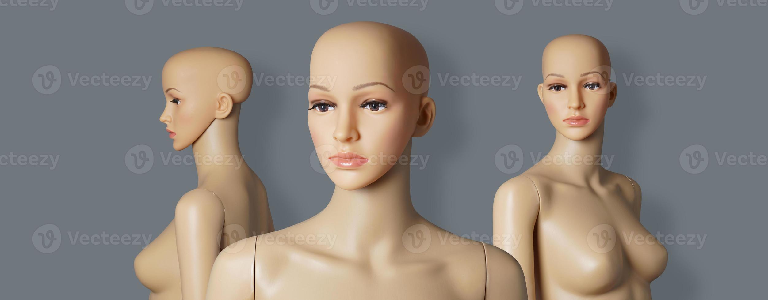 group of 3 naked and bald store window mannequins or display dummies with realistic faces photo
