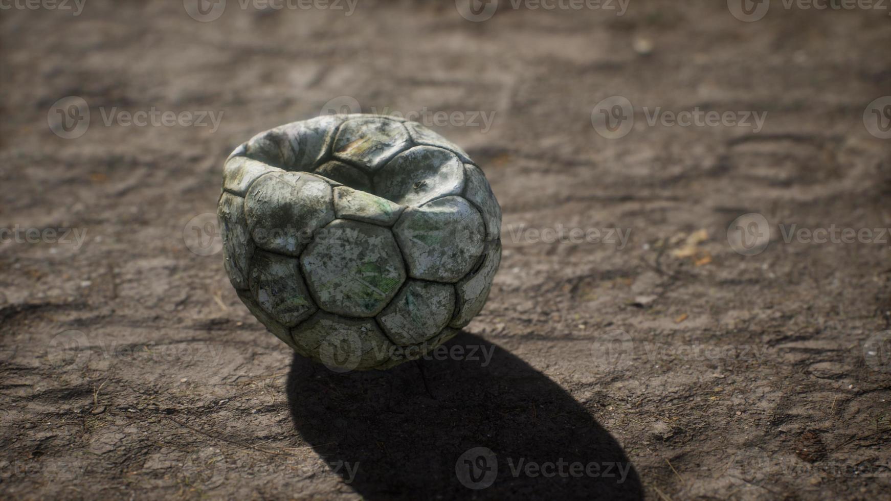 Old soccer ball the cement floor photo