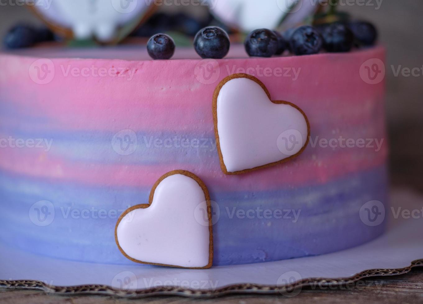 beautiful homemade cake with pink with blue cream, decorated with owl figurines photo