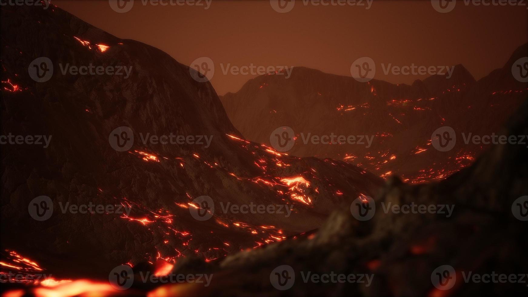 Red Orange vibrant Molten Lava flowing onto grey lavafield and glossy rocky land photo