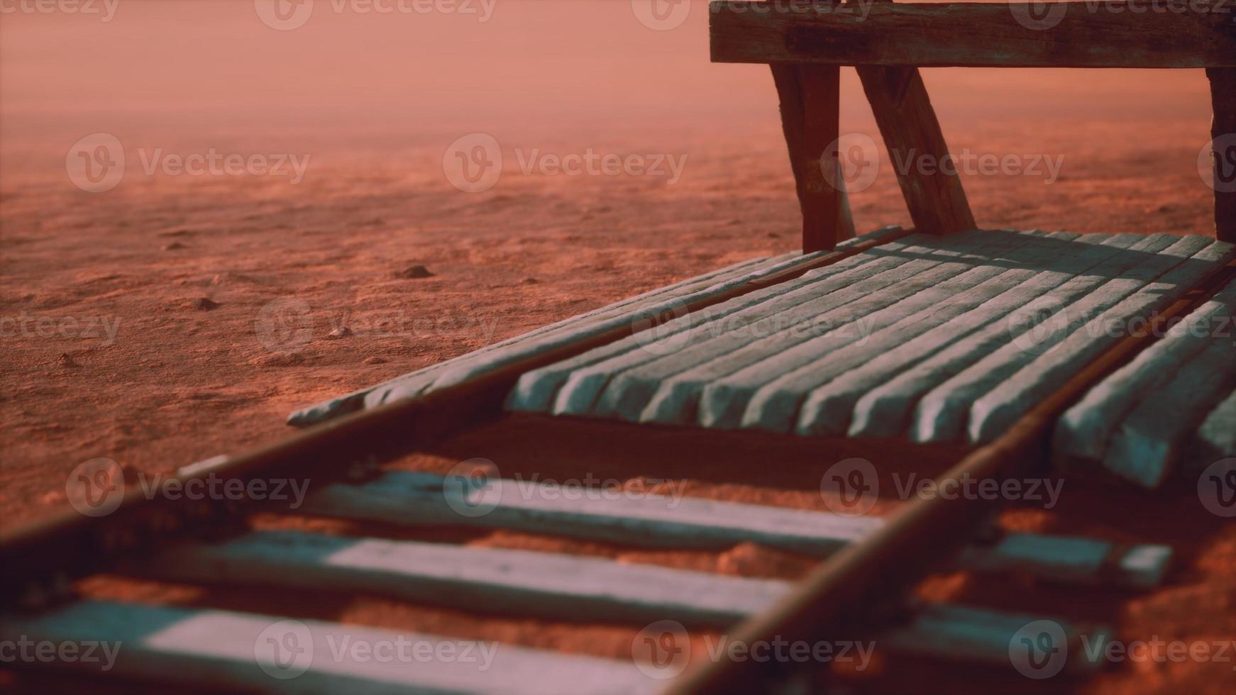 Abandoned railway tracks in the desert photo