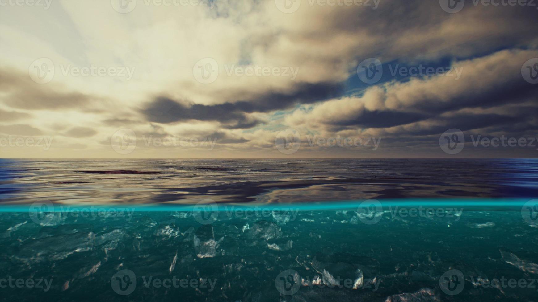 Split view over and under water in the Caribbean sea with clouds photo