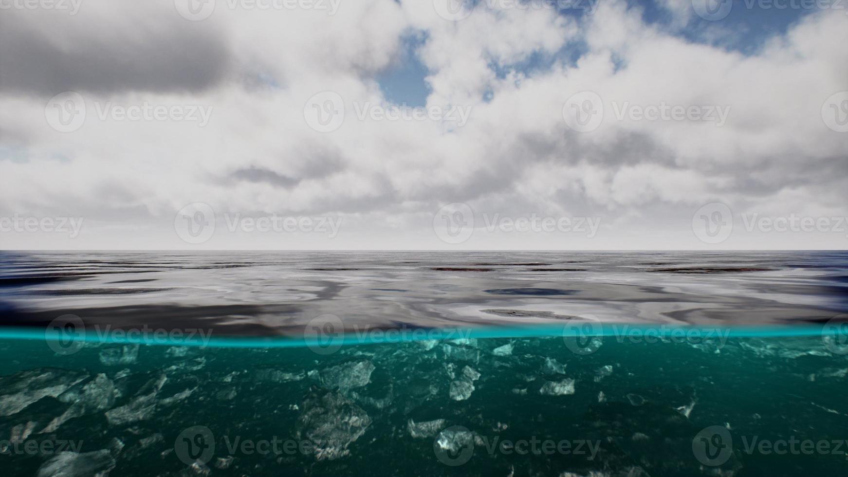 Split view over and under water in the Caribbean sea with clouds photo