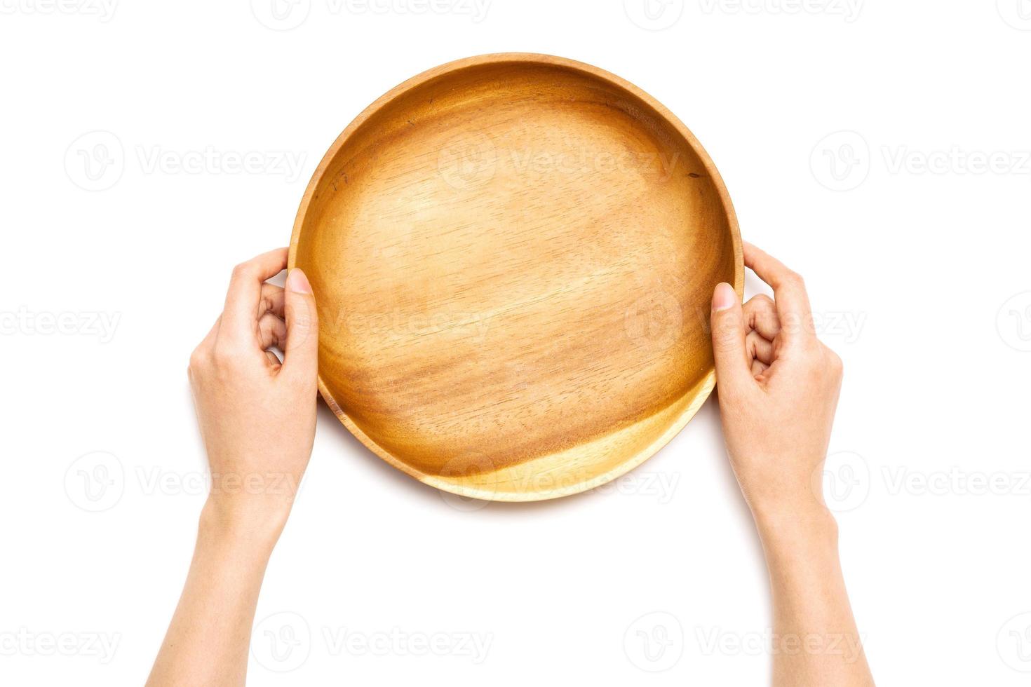 Woman hand hold a wooden tray isolated on white background. photo