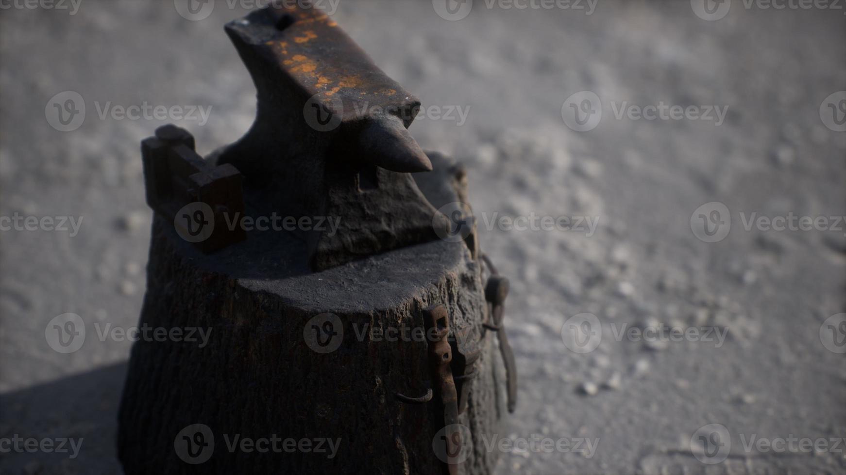 Old anvil attached to a stump photo