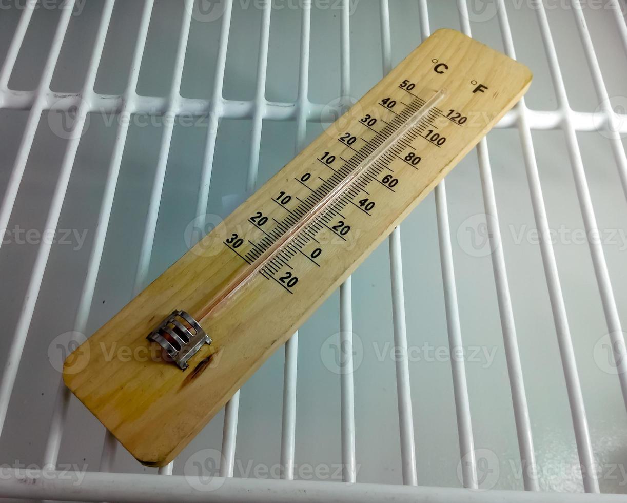 Analog thermometer. closeup. Fridge thermometer. Food, chemical or reagent safety. Refrigerator temperature monitoring device. Mercury thermometer. photo