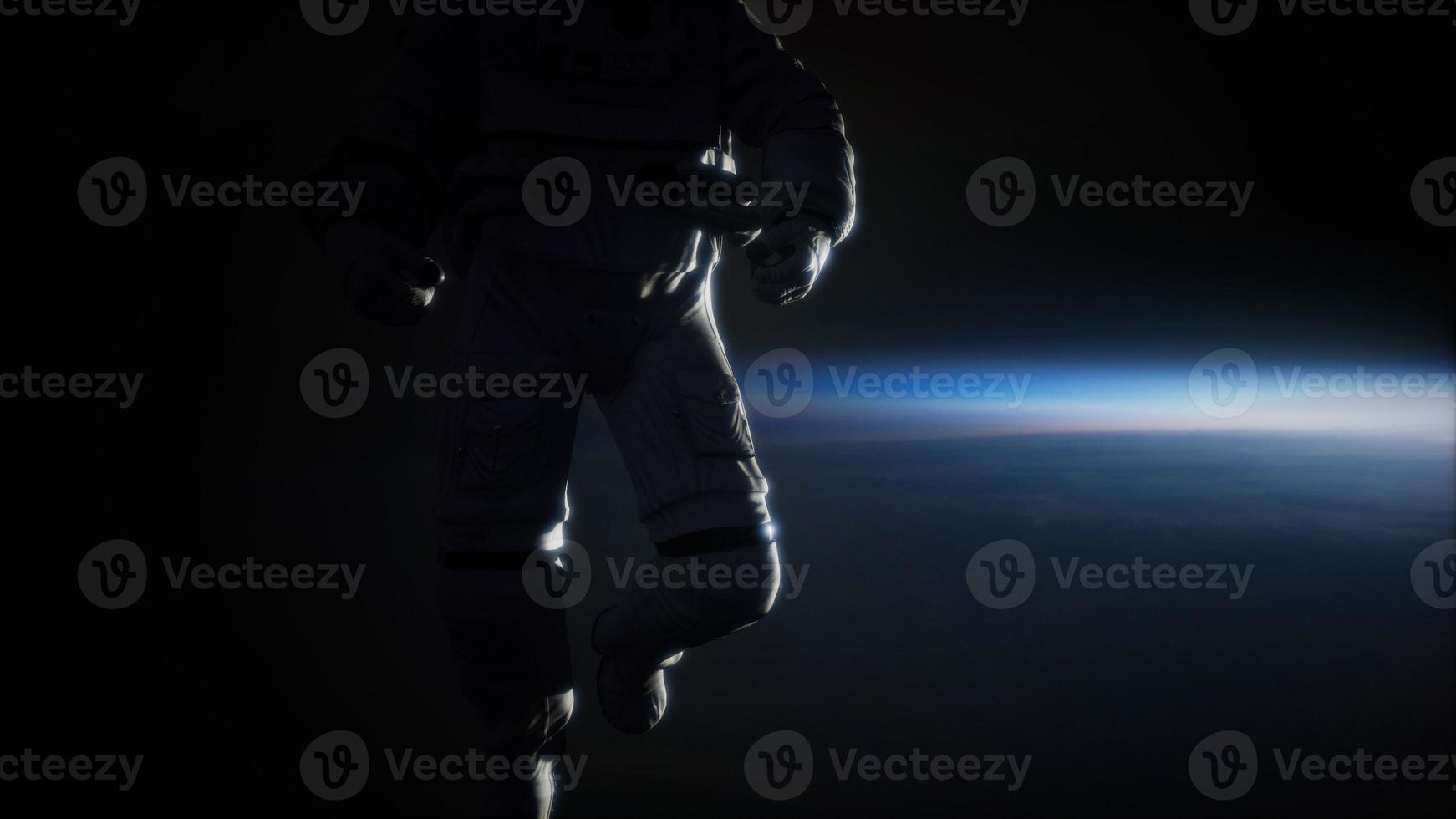 Astronaut in outer space against the backdrop of the planet earth photo