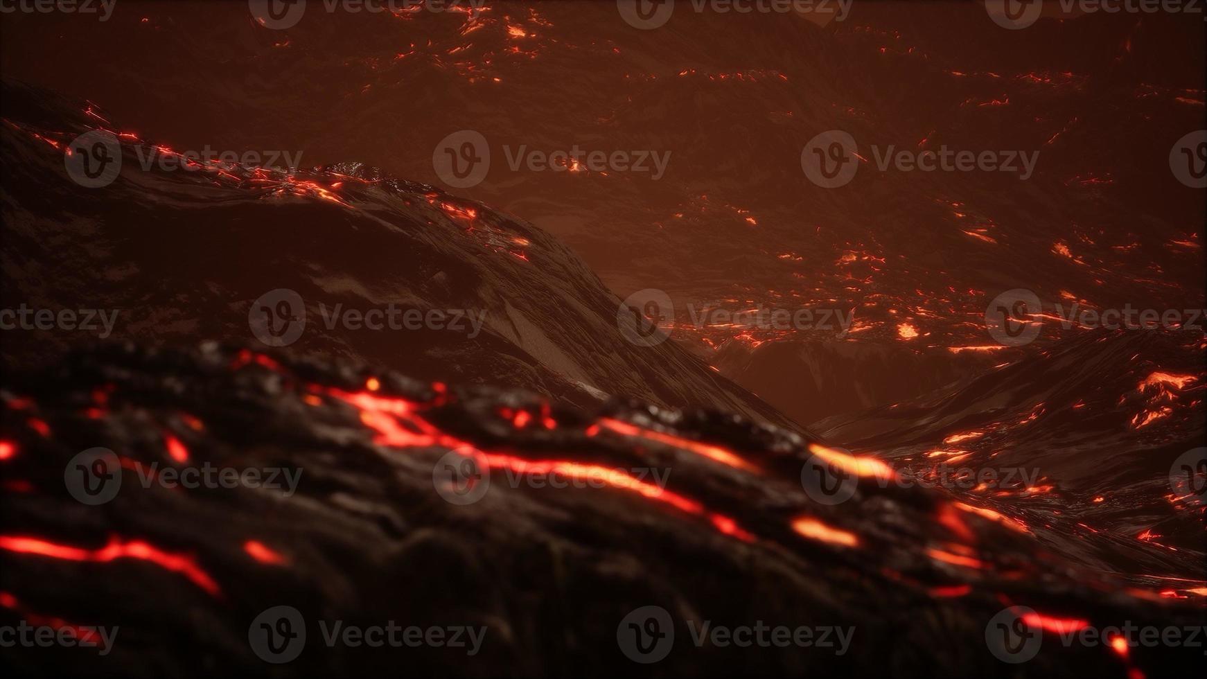 Red Orange vibrant Molten Lava flowing onto grey lavafield and glossy rocky land photo