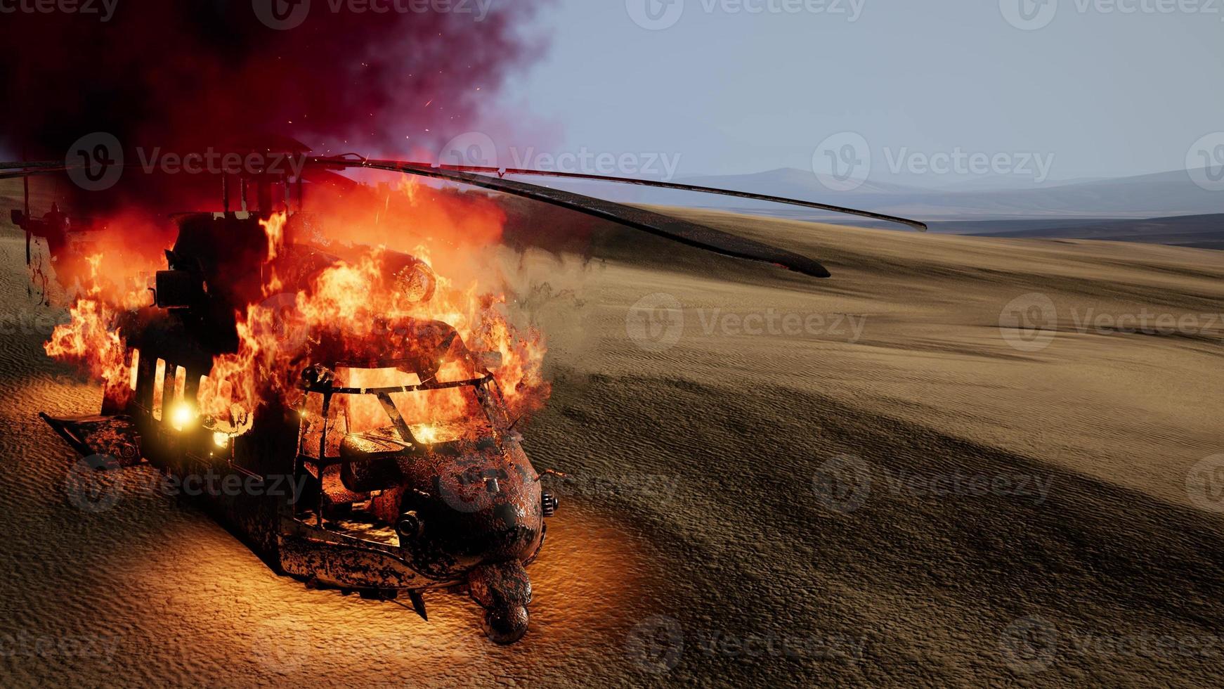 burned military helicopter in the desert at sunset photo