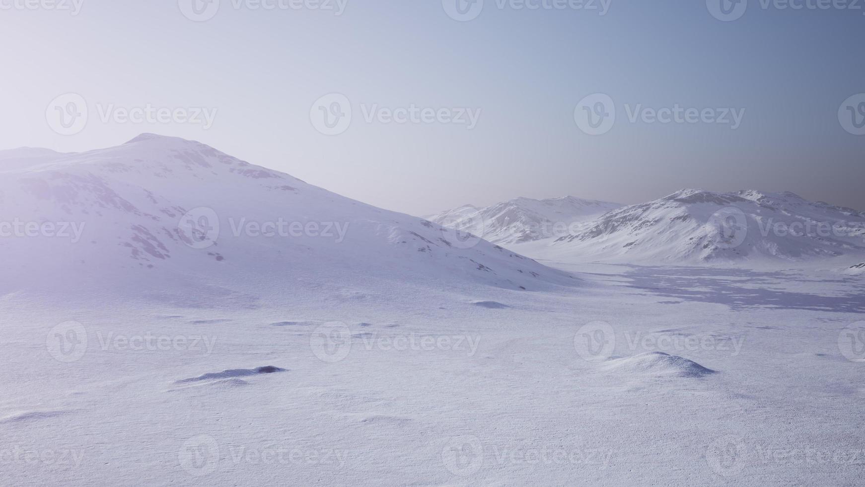 Aerial Landscape of snowy mountains and icy shores in Antarctica photo