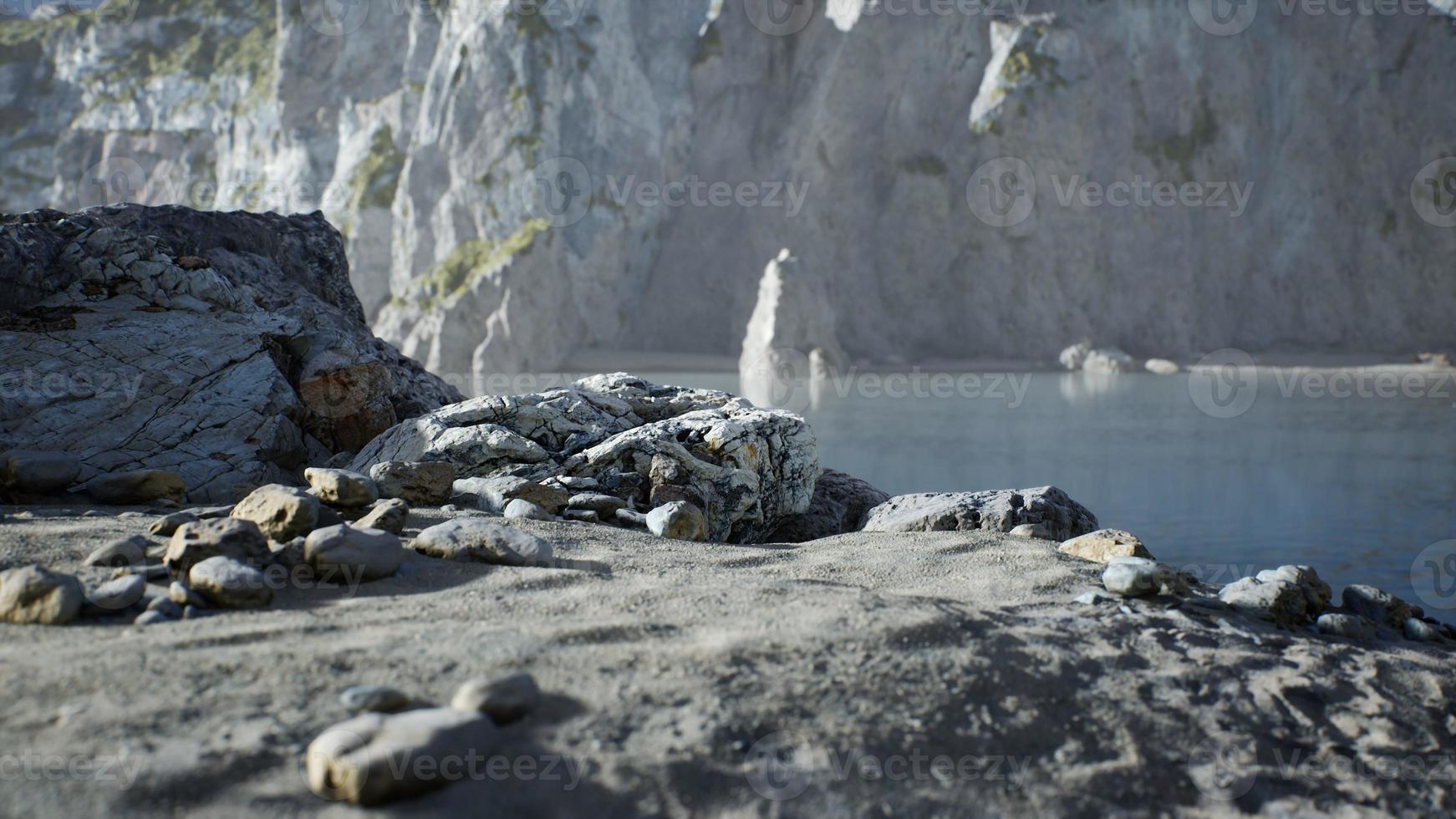 Sand beach among rocks at Atlantic Ocean coast in Portugal photo