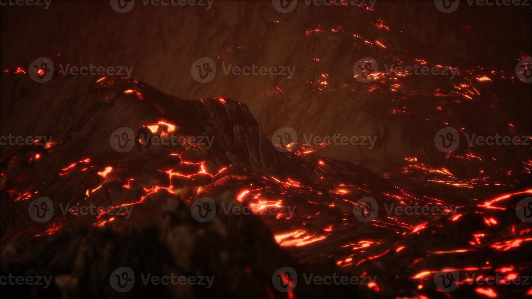 Red Orange vibrant Molten Lava flowing onto grey lavafield and glossy rocky land photo