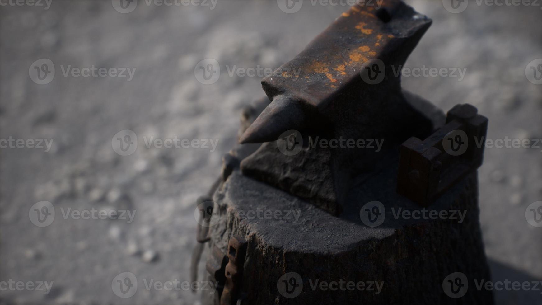 Old anvil attached to a stump photo