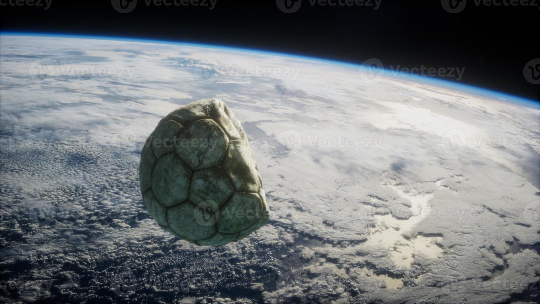 old soccer ball in space on Earth orbit photo