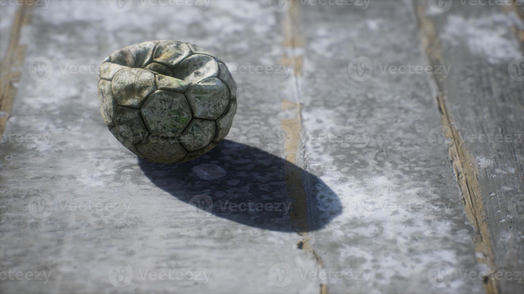 Old soccer ball the cement floor photo