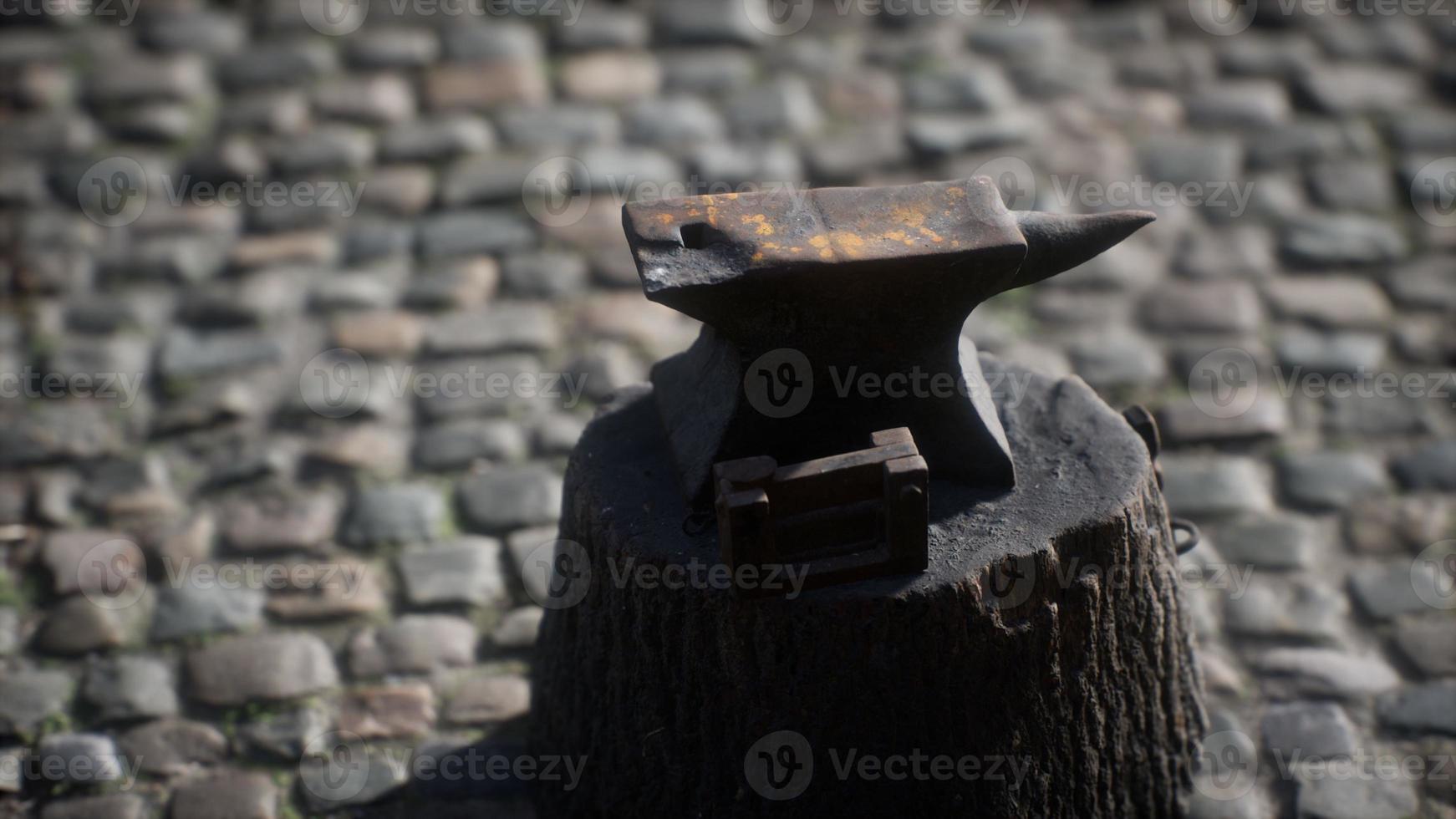 Old anvil attached to a stump photo