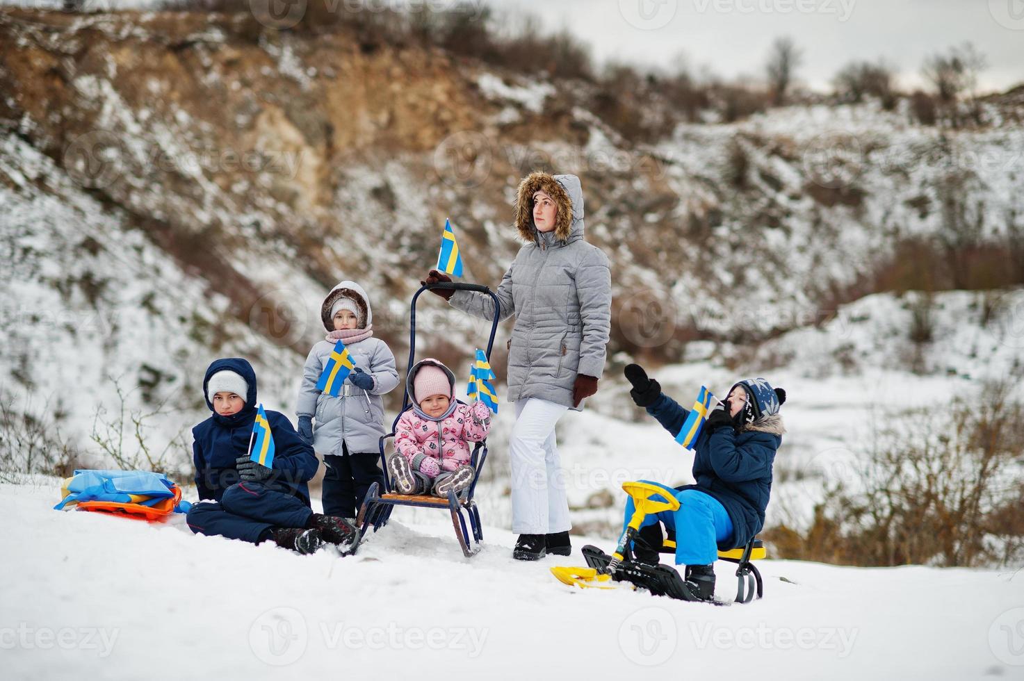 Scandinavian family with Sweden flag in winter swedish landscape. photo