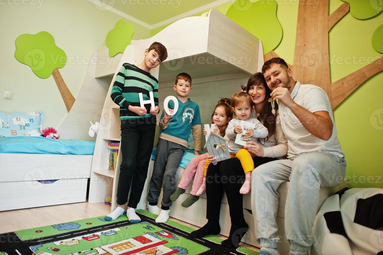 Happy large family in new home hold keys. photo