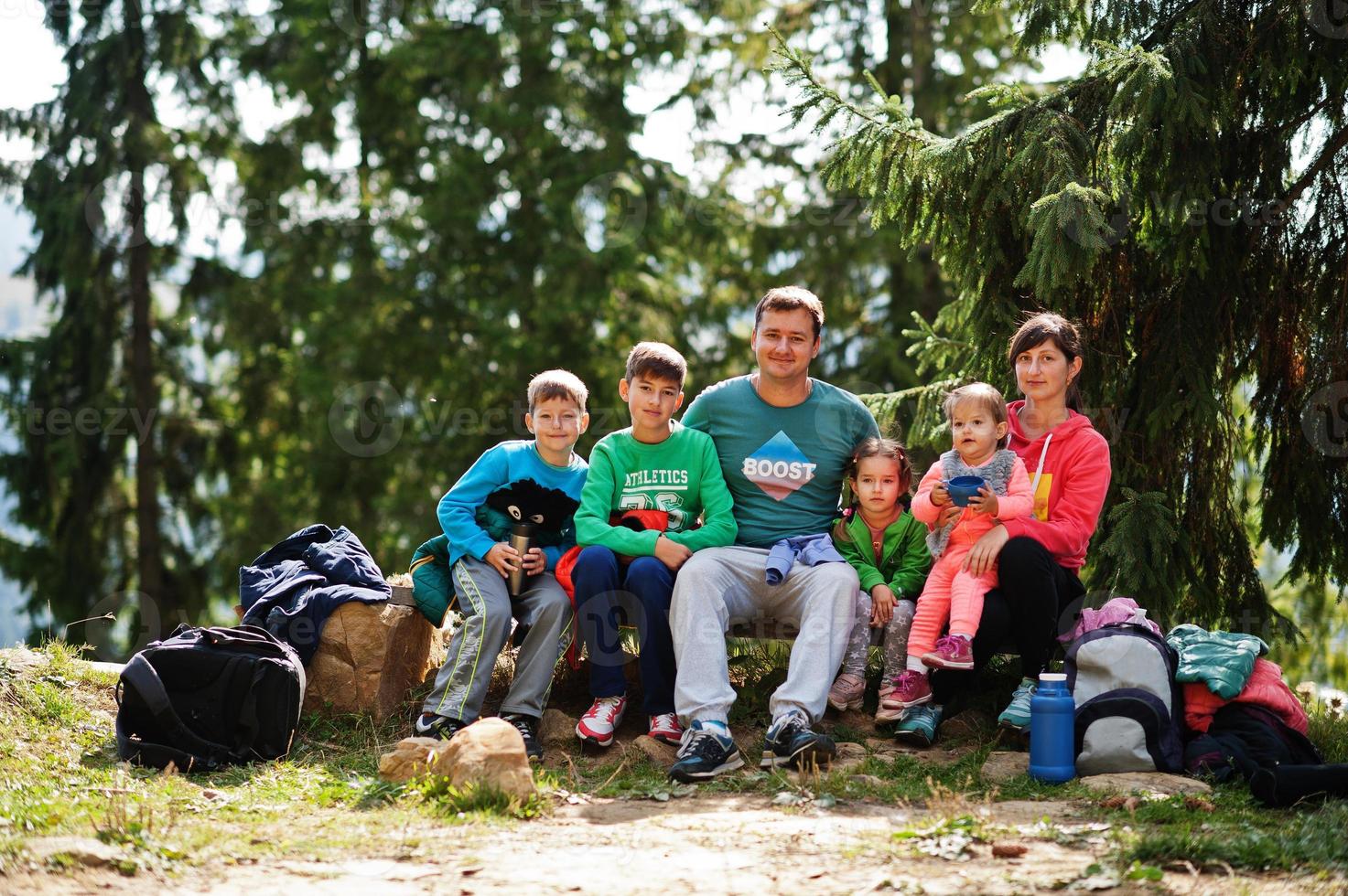 Family with four kids resting in mountains. Travel and hiking with childrens. photo