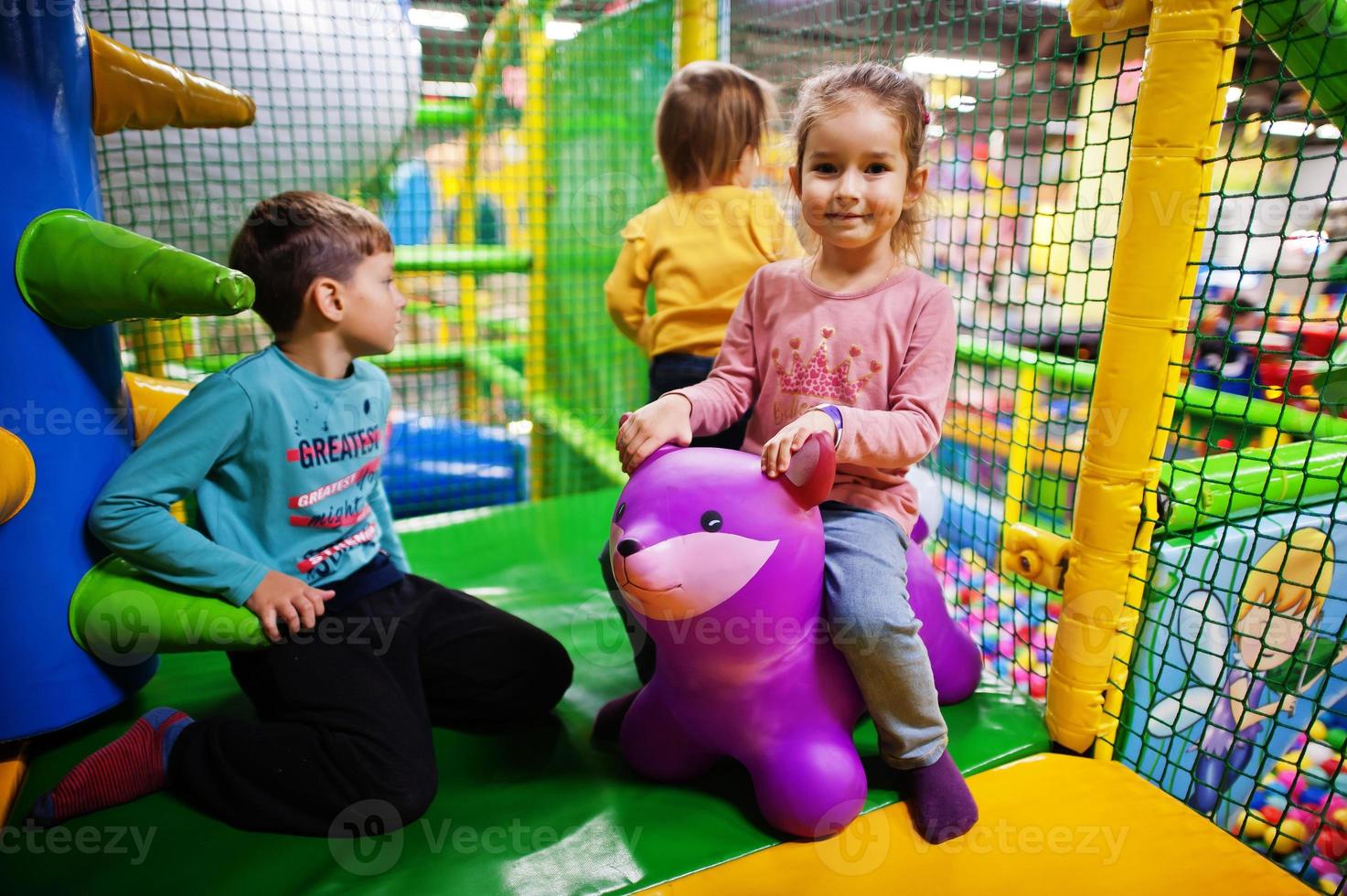 Kids playing in indoor play center. Kindergarten or preschool play room. photo