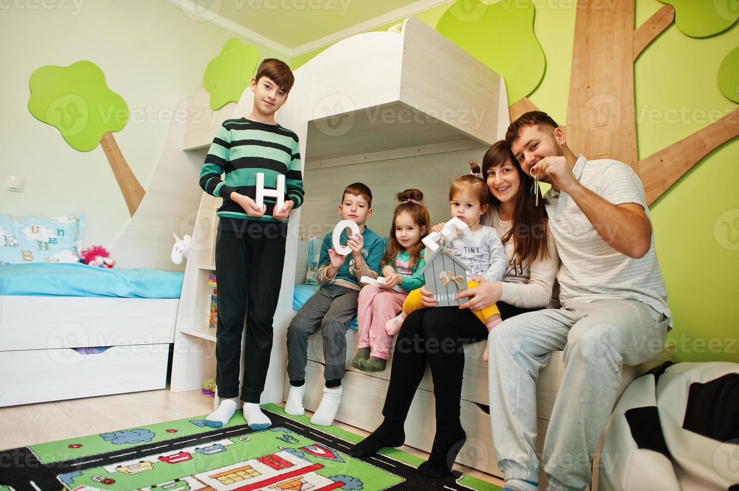 Happy large family in new home hold keys. photo